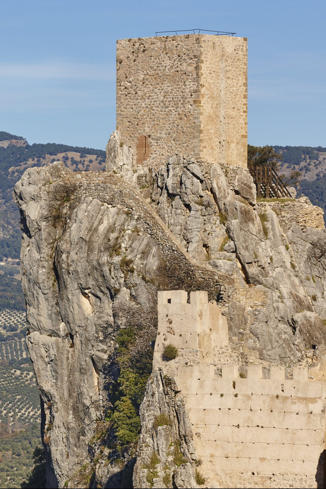 Ancient castle tower and olive fields in La Iruela. Spain