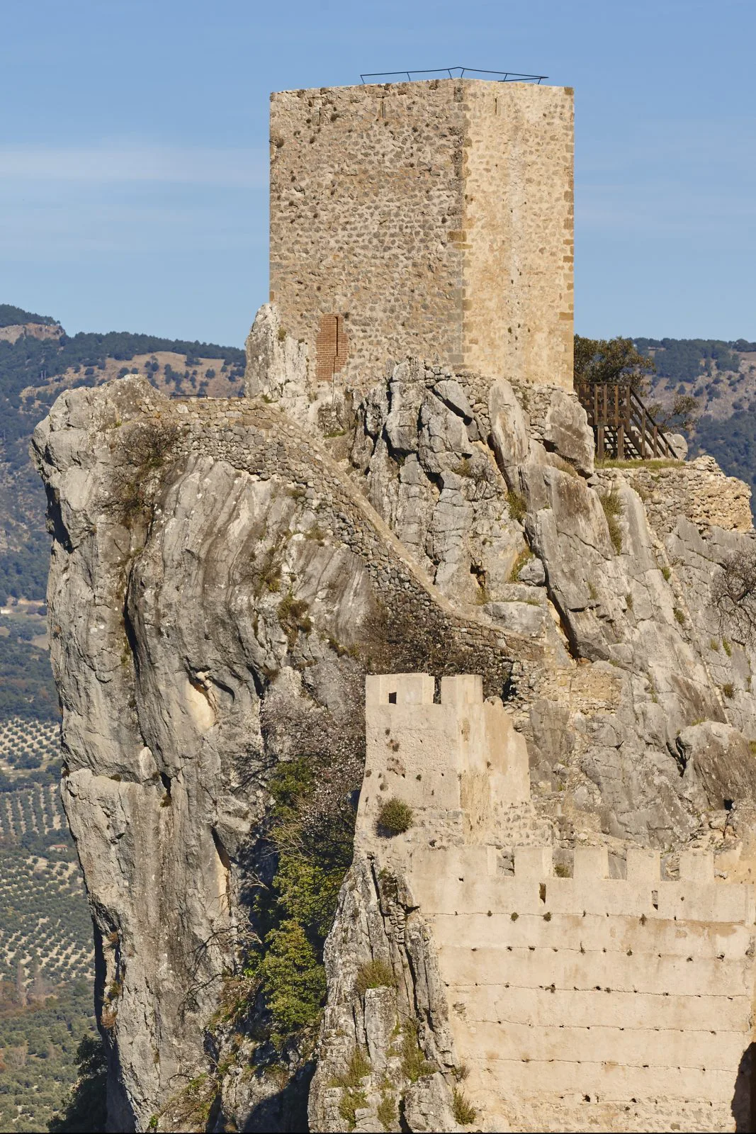 Ancient castle tower and olive fields in La Iruela. Spain